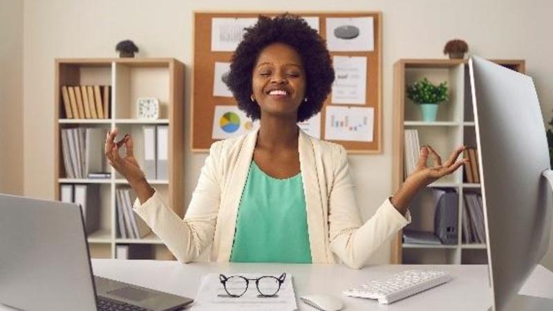 Woman meditating at a computer