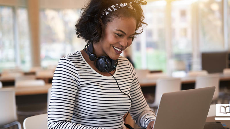 Woman Smiling at a Computer
