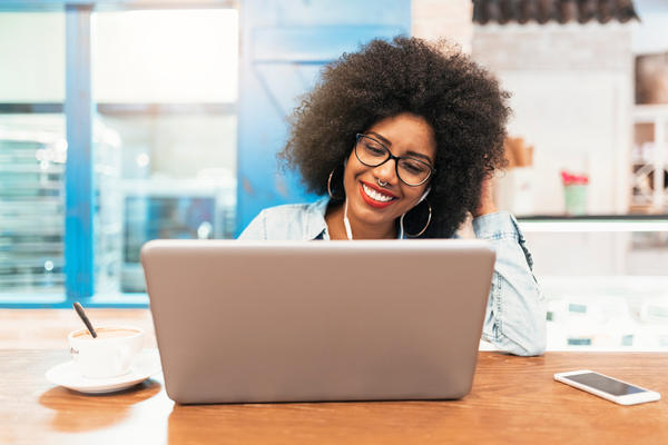 Woman smiling behind a computer