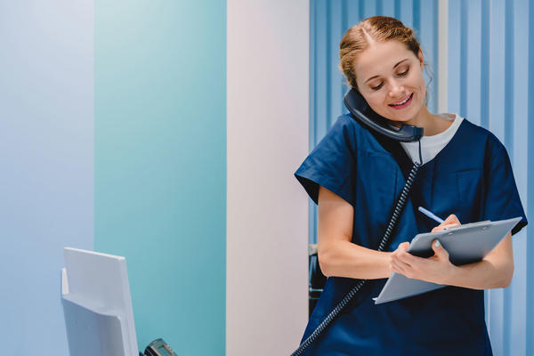 Nurse writing on a chart