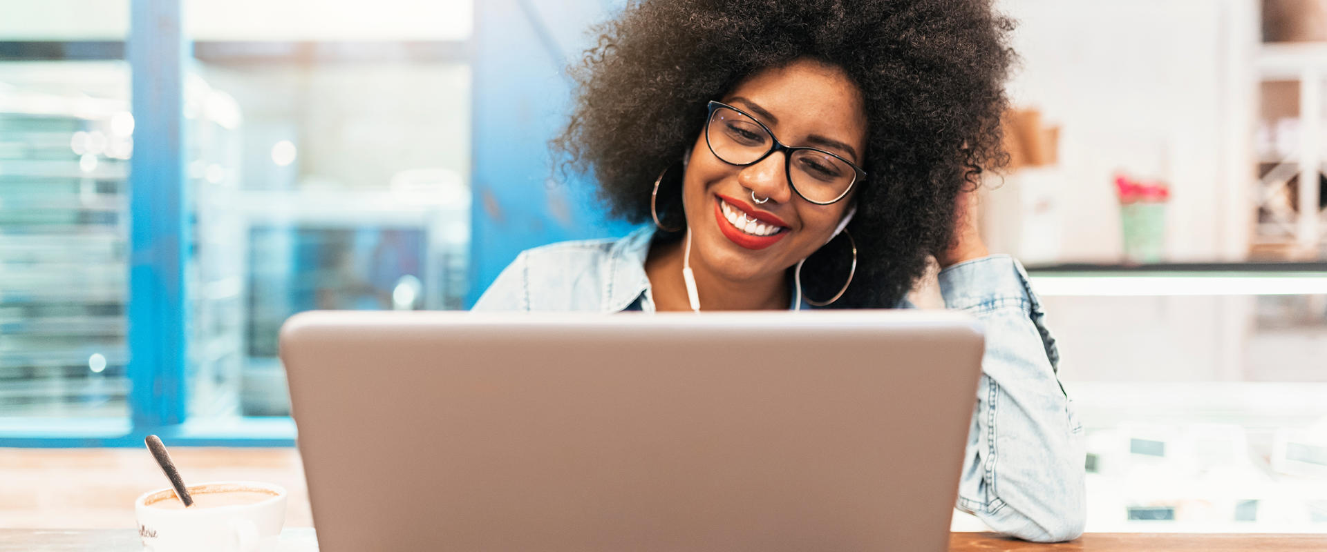 Woman smiling behind a computer