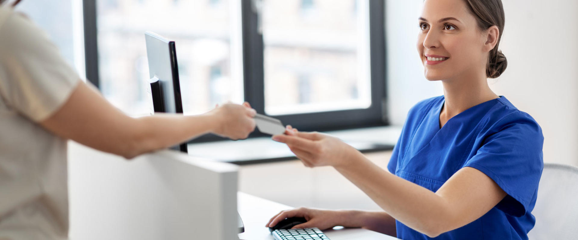 Nursing handing papers to patient