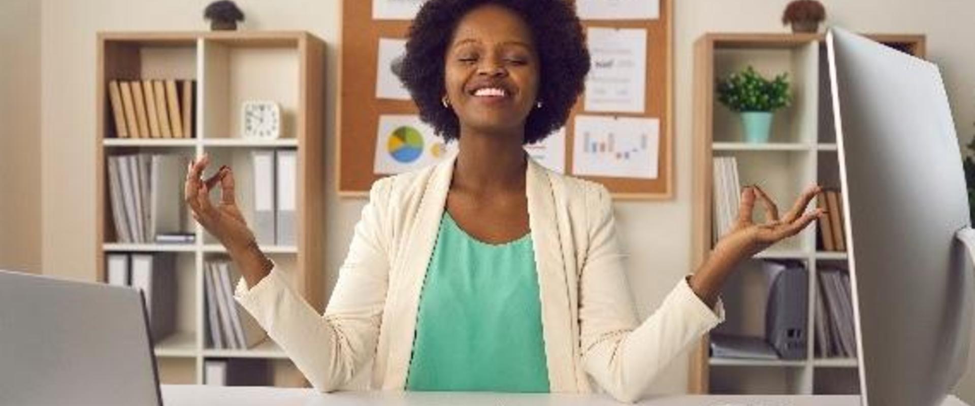 Woman meditating at a computer